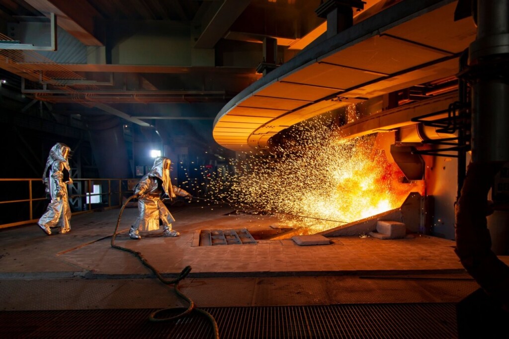 two-factory-workers-igniting-a-furnace-in-an-indus-2026-01-07-07-18-02-utc